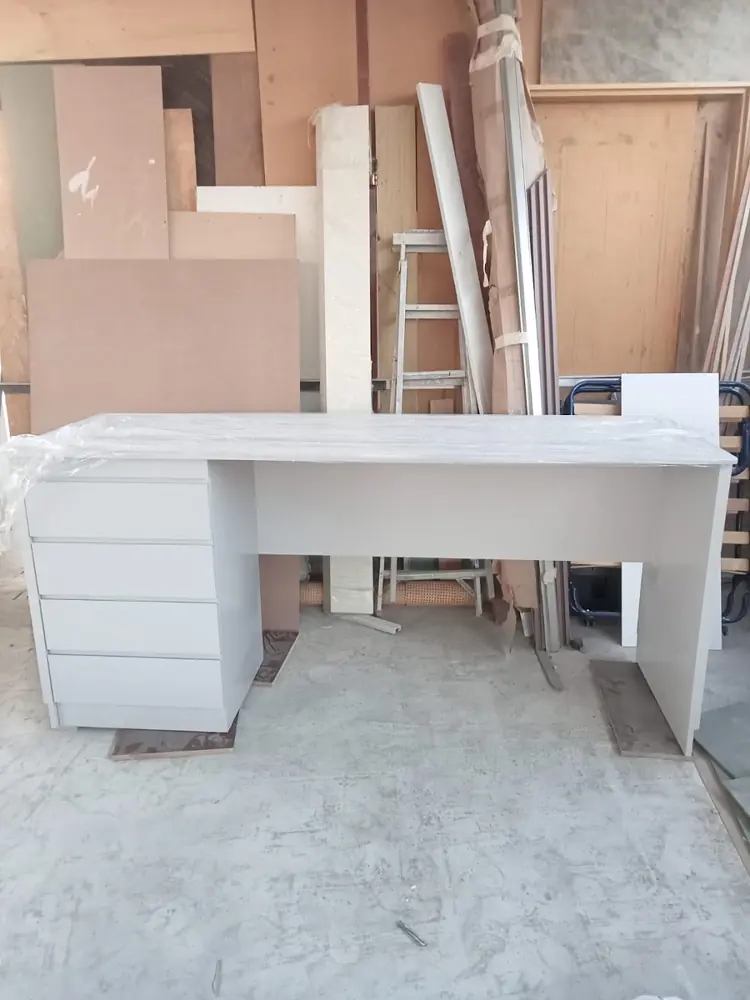 White desk with a drawer bank, finished in the workshop